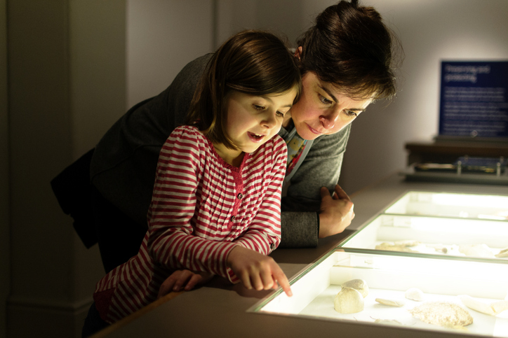 A mother and daughter look at items in a Museum