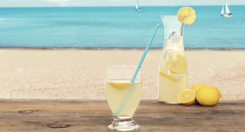 Lemonade sits on a beach