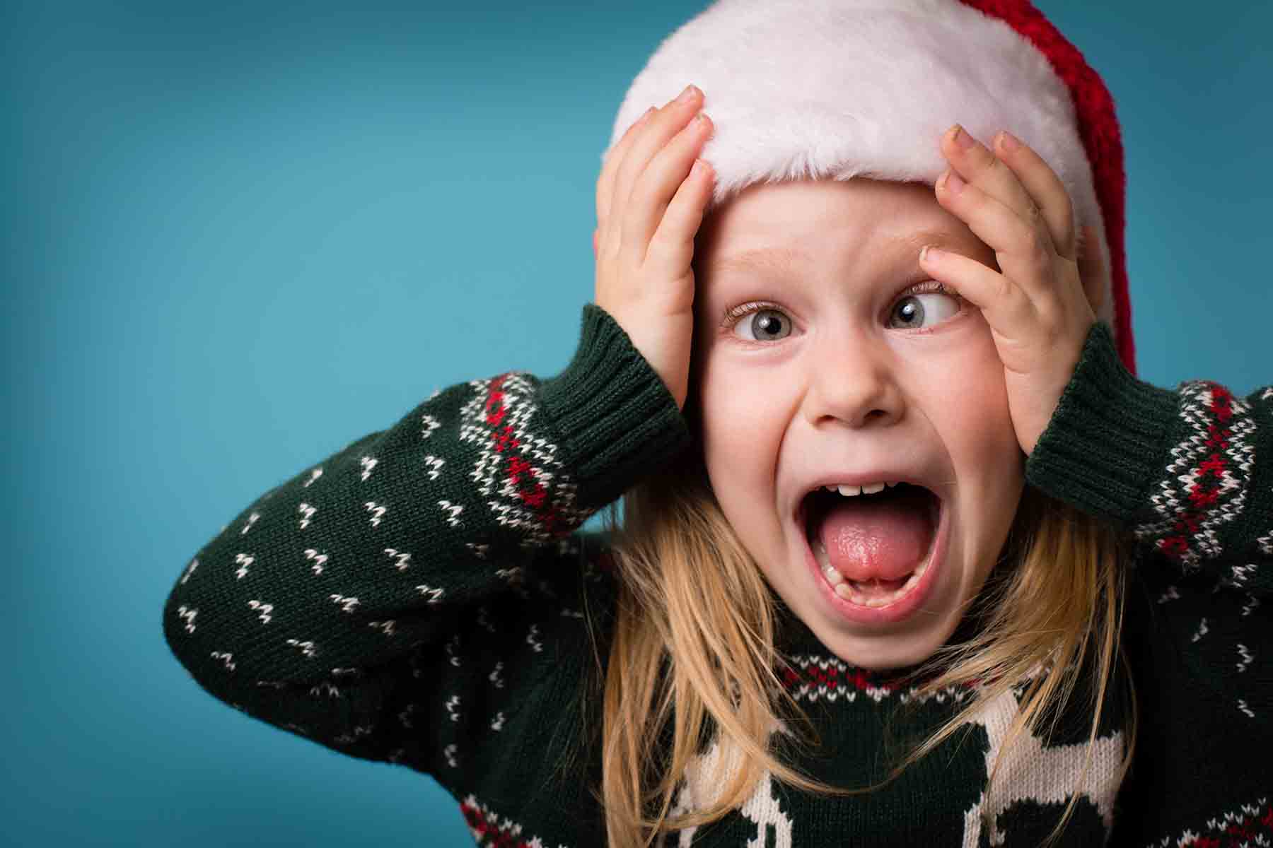 Very excited young girl in a holiday sweater